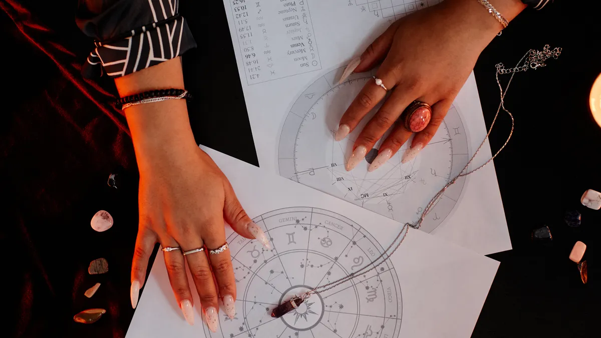 saturn transit: hands reading astrology chart illustration